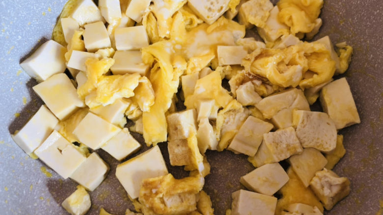 豆腐炒鸡蛋,待蛋液定型后用筷子打散，盛出备用。