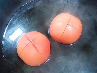 茄汁龙利鱼,锅中烧开水，放入西红柿烫一下外皮，四周都烫一下取出。