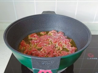 炒口蘑,锅里放适量的食用油，油温五成热放入牛肉丝爆炒。