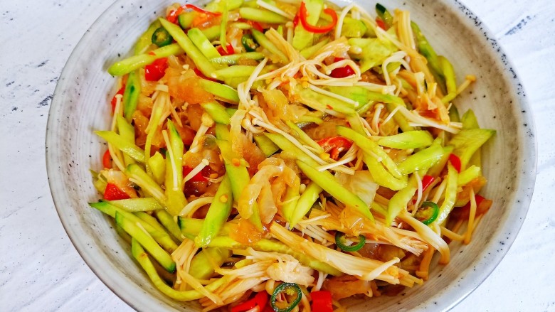 黄瓜凉拌金针菇,用筷子搅拌均匀。