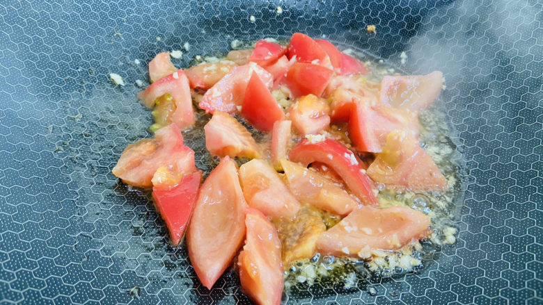 西红柿炒豆腐,放入西红柿翻炒片刻至出汤汁
