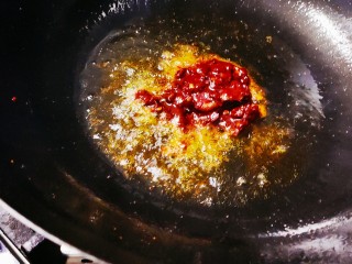 水煮肥牛,锅中加入适量的油，油热后加入豆瓣酱，翻炒出红油