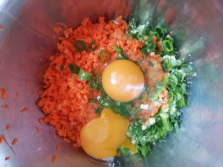 胡萝卜鸡蛋饼,把胡萝卜西兰花葱花都放入盆中，打入两个鸡蛋