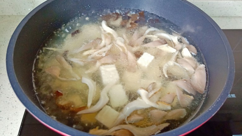 平菇豆腐汤,加入豆腐开大火炖煮。