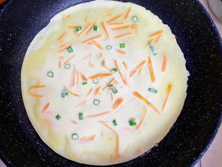 胡萝卜鸡蛋饼,用大勺舀入饼浆，平底锅铺平即可，双面煎熟。
