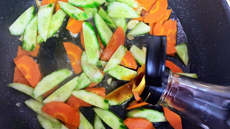 黄瓜炒胡萝卜,倒入适量酱油。