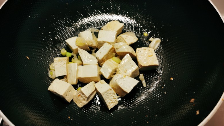 榨菜豆腐汤,再起油锅放入1汤匙食用油，放入葱片炒香，放入豆腐翻炒。