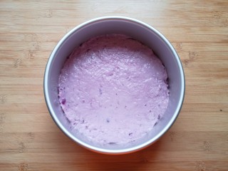 紫薯发糕,倒入搅拌好的紫薯面糊，勺子沾水将表面抹平，盖上保鲜膜发酵至两倍大。