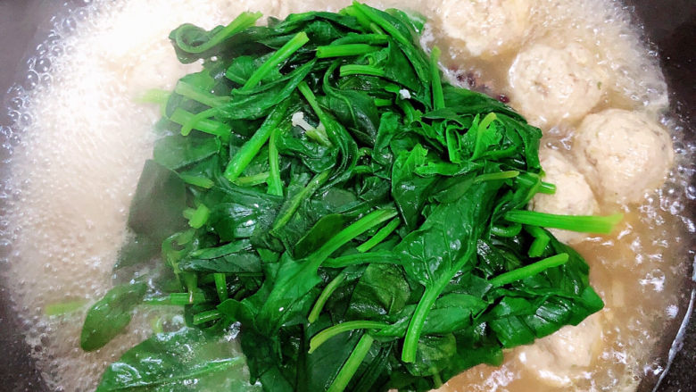 菠菜鱼丸汤,放入烫好的菠菜，搅拌均匀，让菠菜入味。