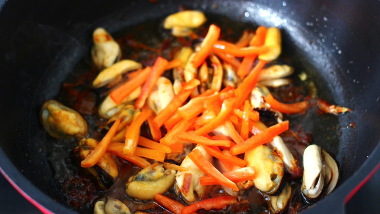 酱香蒜苔青口小炒,加入红椒丝，继续煸炒片刻。