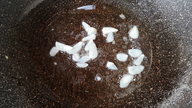西葫芦炒鸡蛋,锅里继续倒油烧热，下入蒜片炒香。