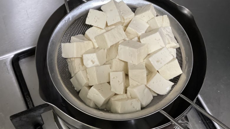 香椿拌豆腐，这才是春天该有的味道,把北豆腐也下沸水，焯水一分钟，捞出沥水。