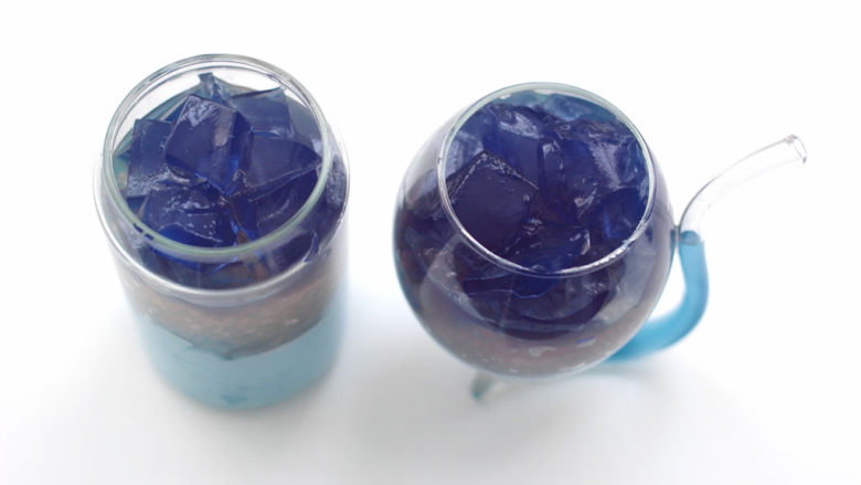 蓝蝴蝶奶冻西米露,水晶果冻切块放入杯子上面。