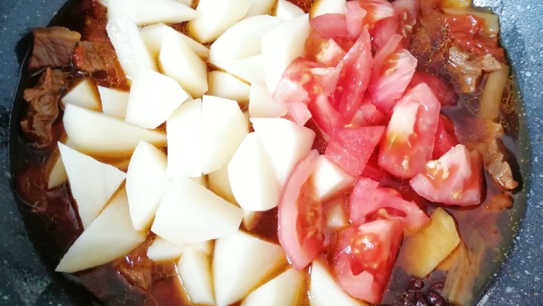 西红柿土豆炖牛肉,一个小时之后，下入土豆块和剩下的一半西红柿翻炒均匀，继续中小火炖10分钟左右(土豆熟了即可)。 