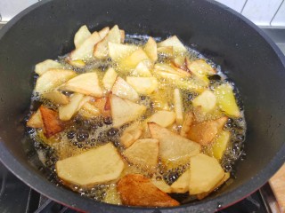 家常地三鲜,土豆放入油锅，炸熟捞出控油