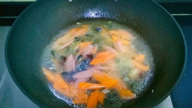 上汤西兰花,加入胡萝卜和火腿肠片翻炒片刻，加入适量清水煮开，转小火煮2分钟