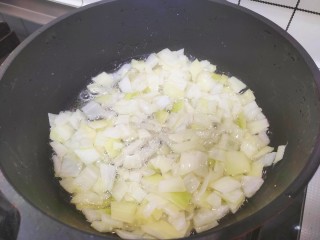 香菇卤肉饭,锅中加入适量食用油，可以稍微多一点点，然后把洋葱丁放入锅中，炸至洋葱变得金黄，捞出来备用。油也全部倒出去，这个油就不需要了，一会儿要用这个洋葱。