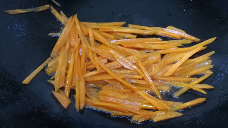 素卷三丝,热锅中倒入适量油，放入胡萝卜划炒一下，营养物质更易吸收。