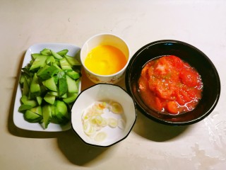 番茄黄瓜炒蛋,鸡蛋打散、黄瓜切片、葱切片、番茄去皮切块。