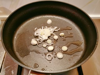 西芹炒百合,起油锅放入食用油，油热后放入葱片炒香。