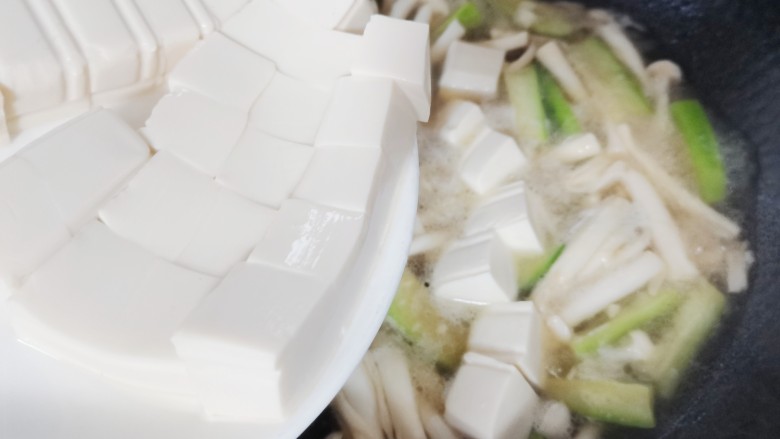 海鲜菇豆腐汤,倒入豆腐烧两分钟
