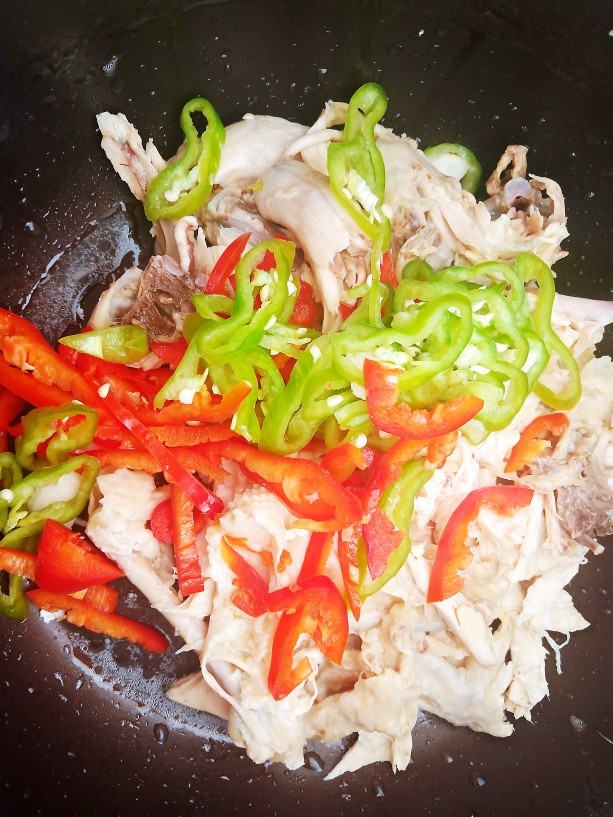 椒麻手撕鸡,浸泡过的鸡肉撕成小块，再加入青红椒丝。