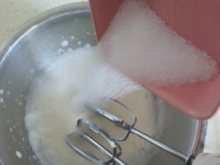 云朵舒芙蕾蛋糕,蛋白中滴几点柠檬汁，电动打蛋器先低速打发至粗泡泡，继续打发至泡沫变的细腻，加入0卡糖继续高速打发