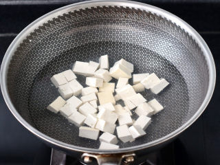 豆腐蛋花汤,锅中倒入适量的清水，加入少许盐，放入豆腐焯一下水，这样做出来的汤汁清澈干净，豆腐的口感更加细腻。