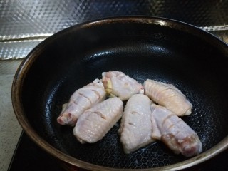 蒜香焖翅,放鸡翅煎制两面微黄。
