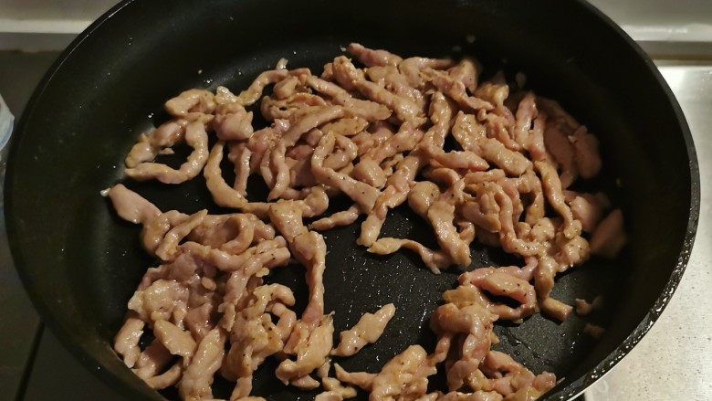 彩椒炒肉丝,再起油锅放入1汤匙食用油，油热后放入肉丝翻炒变色。
