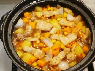 五花肉焖饭,将蔬菜和汤汁倒入大米上面，扣上盖子焖熟。