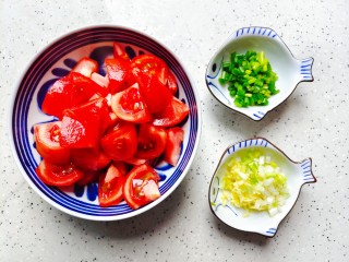 番茄炒鱼片,番茄去皮洗净别成小块，生姜去皮洗净切成末，葱洗净切碎，葱白部分和生姜放一起