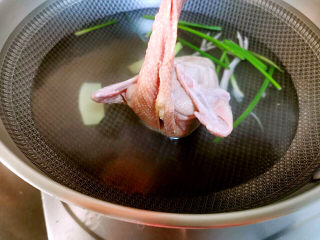 桃胶姬松茸炖鸽子,水锅中加入葱姜，料酒，下鸽子，进行1分钟快速焯水