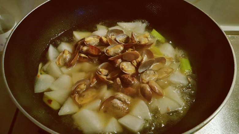 萝卜蛤蜊汤,将蛤蜊放入汤中继续煮。