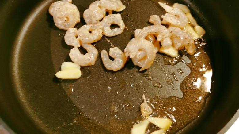 腐竹炒虾仁,起油锅放入食用油，油热后放入蒜片炒出香味，放入虾仁翻炒变色。