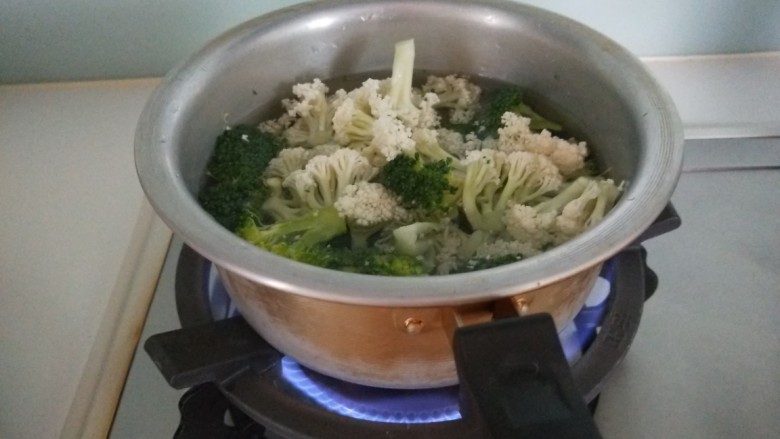 椒盐花菜,锅中放入适量水烧热，倒入二花。