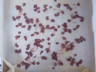 抹茶红豆蛋糕卷,烤盘中铺上油纸，撒上蜜红豆