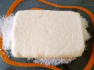 椰丝牛奶小方糕,.将冷藏后的成品倒在铺有椰蓉的垫板上
