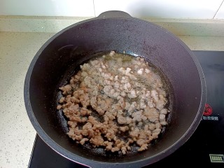 肉酱拌面,锅里放一点底油，下肉丁翻炒至微黄，加一勺料酒去腥。