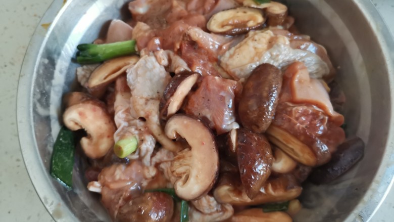 姜葱冬菇蒸滑鸡,再加入冬菇抓拌均匀腌制片刻