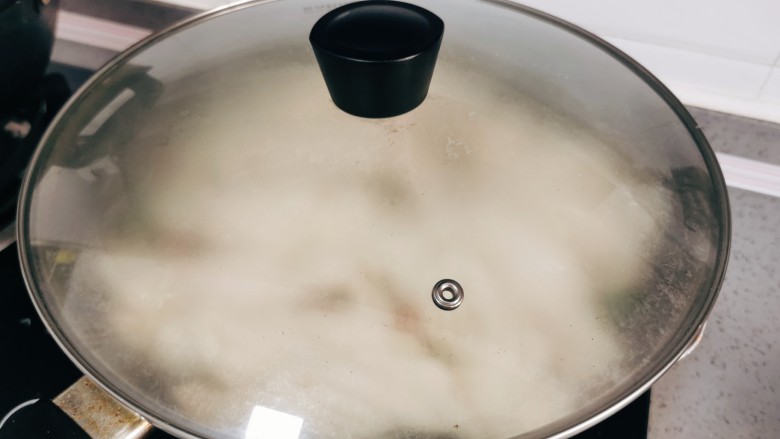 豆角焖卷子,盖上锅盖，焖煮至上汽后，计时10分钟