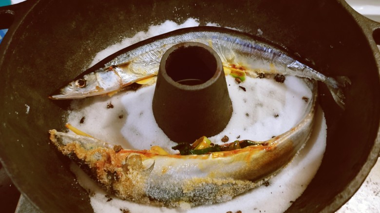 盐焗烤鱼,将鱼放到锅里，平放到锅中剩下的盐上面。