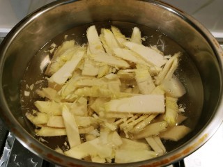 腊肉炒冬笋,冬笋片放入开水中煮两分钟，捞出备用。