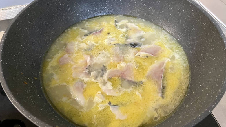 金汤鱼,再次煮开，保持小火一片片加入鱼肉，煮到鱼肉发白浮起