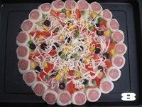 【花边培根披萨】换着花样吃披萨,表面撒适量马苏里拉奶酪，并沿饼皮花边均匀刷一层蛋液。