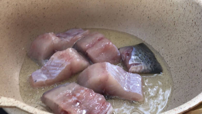 平菇豆腐清炖鱼汤,放入热油锅中，煎至两面金黄