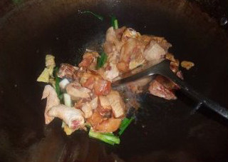 板栗焖鸡,炒锅里的余油再次烧热，放入腌好的鸡块，姜片和葱段
