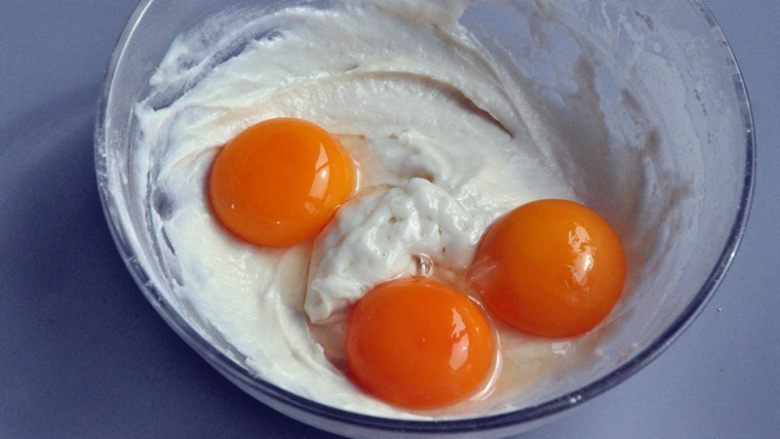 草莓奶油蛋糕盒子,将蛋清和蛋黄分离，蛋黄放入混合好的面糊中。