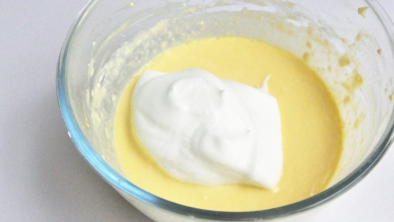 轻芝士蛋糕,分次将蛋白霜加入到蛋黄奶酪糊中，切拌均匀。