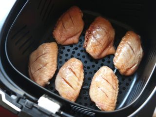 无油照烧烤鸡翅,腌好的鸡翅铺在炸锅的炸篮里。